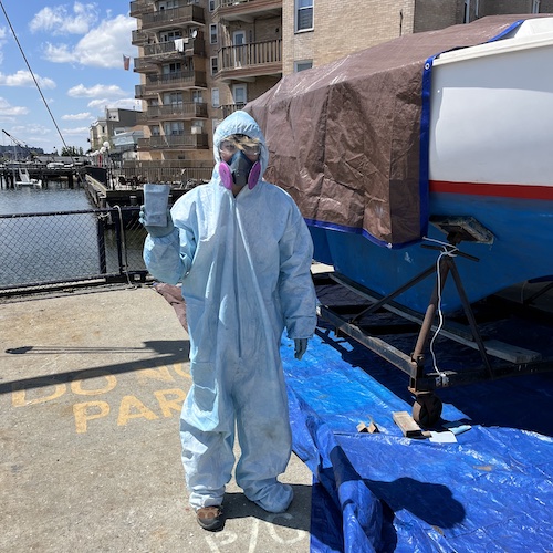 Blue dude, sanding a boat bottom in Sheepshead Bay
