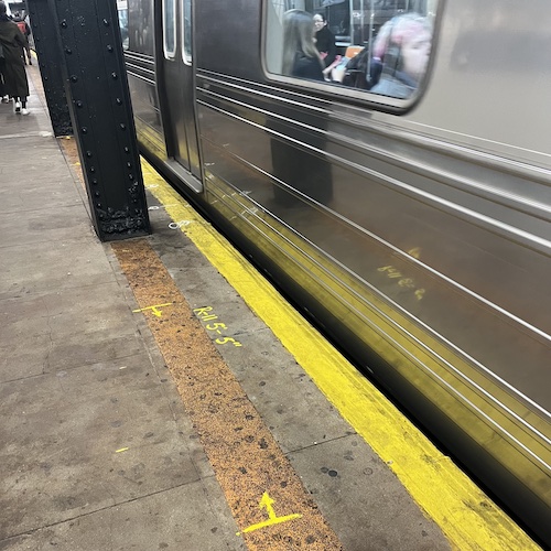 Spray paint marks the spot of soon to be installed subway platform barriers. 7th Avenue Station, Park Slope, Brooklyn.